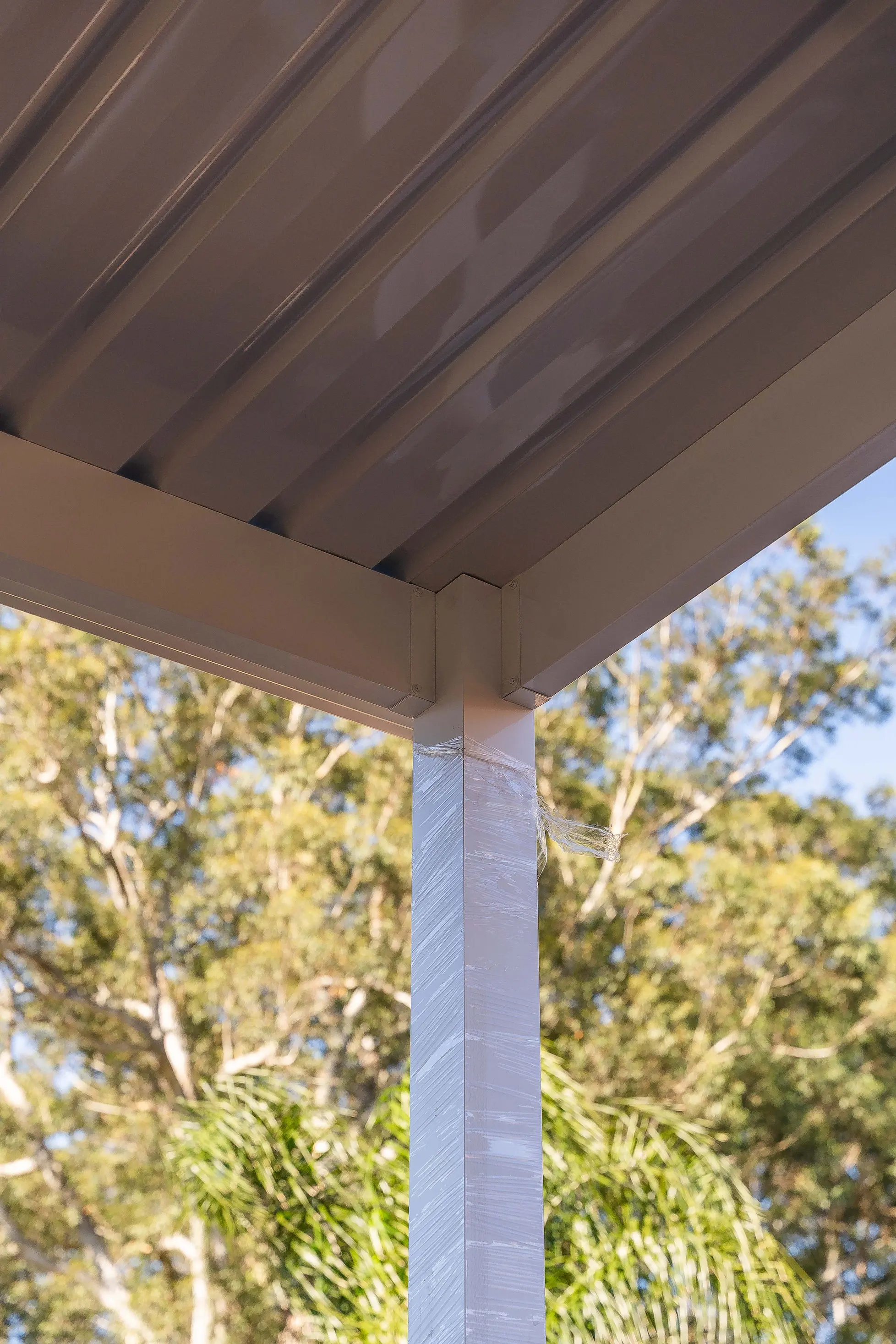 Portrait of the roof edge and gutter run along the carport perimeter