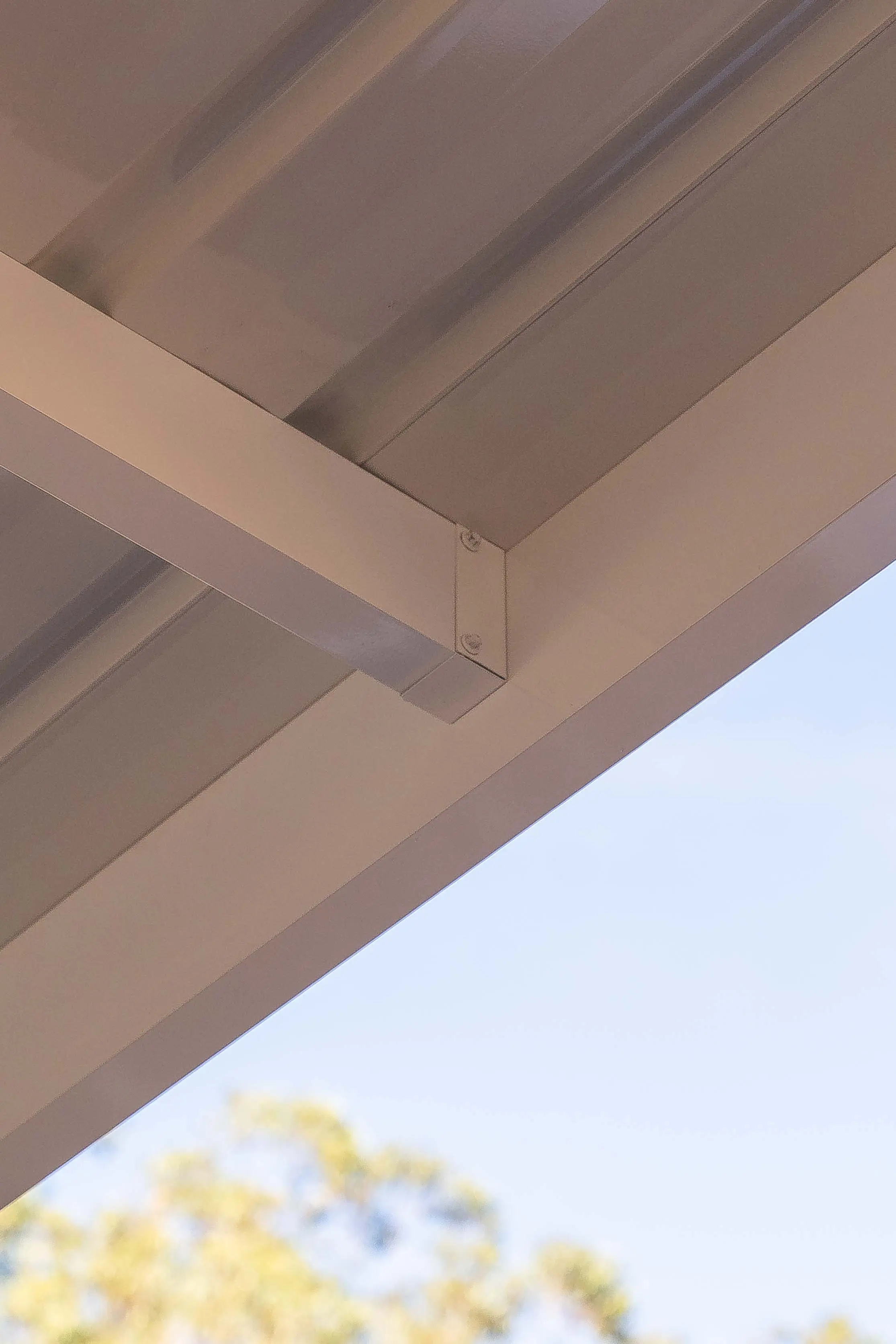 High-angle portrait of the carport bay looking toward the house facade
