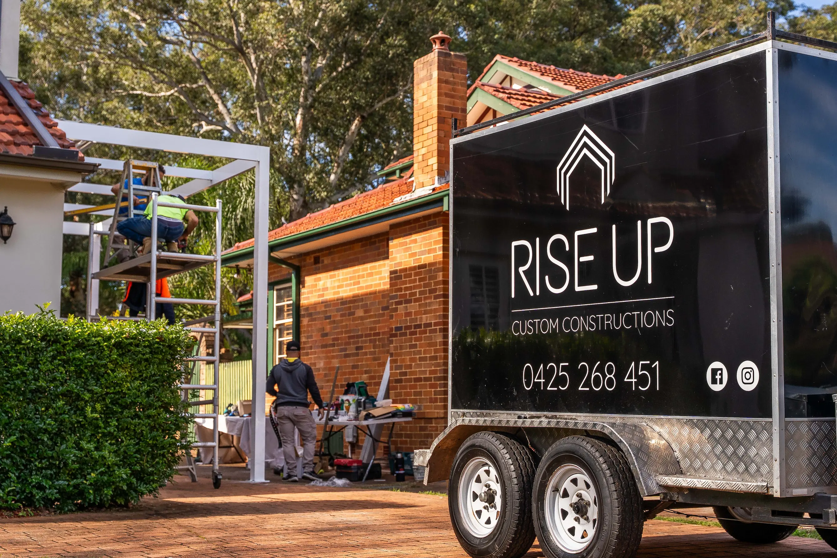 Full-width steel-framed carport covering the parking zone with open sides