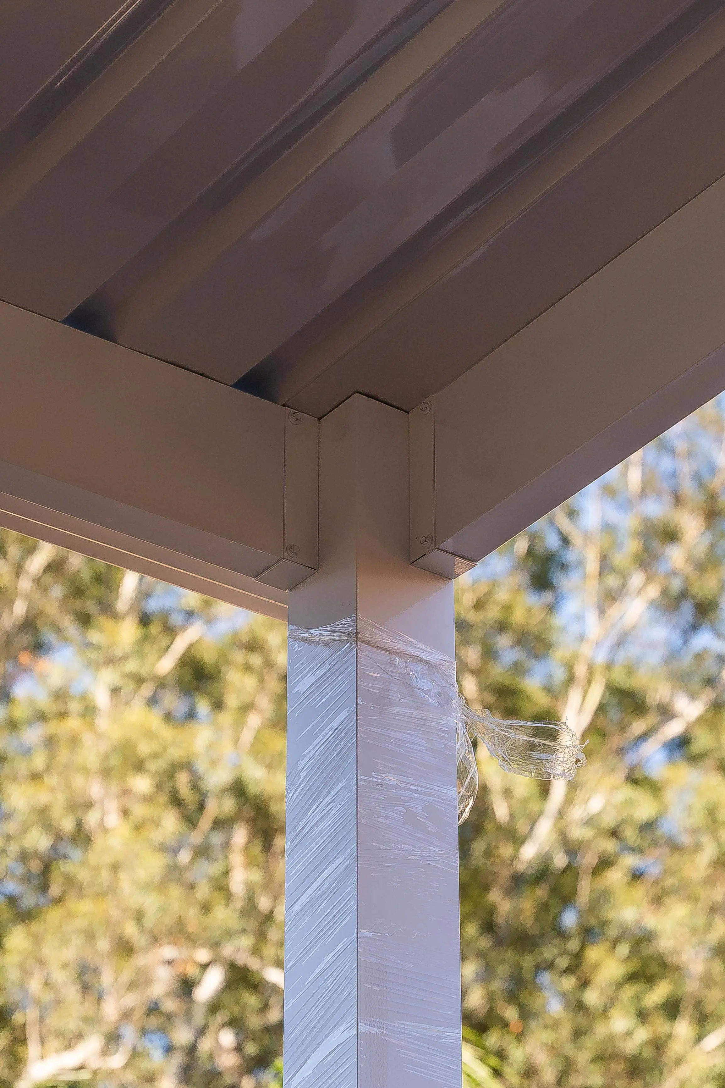 Tall view through the open carport toward the street frontage