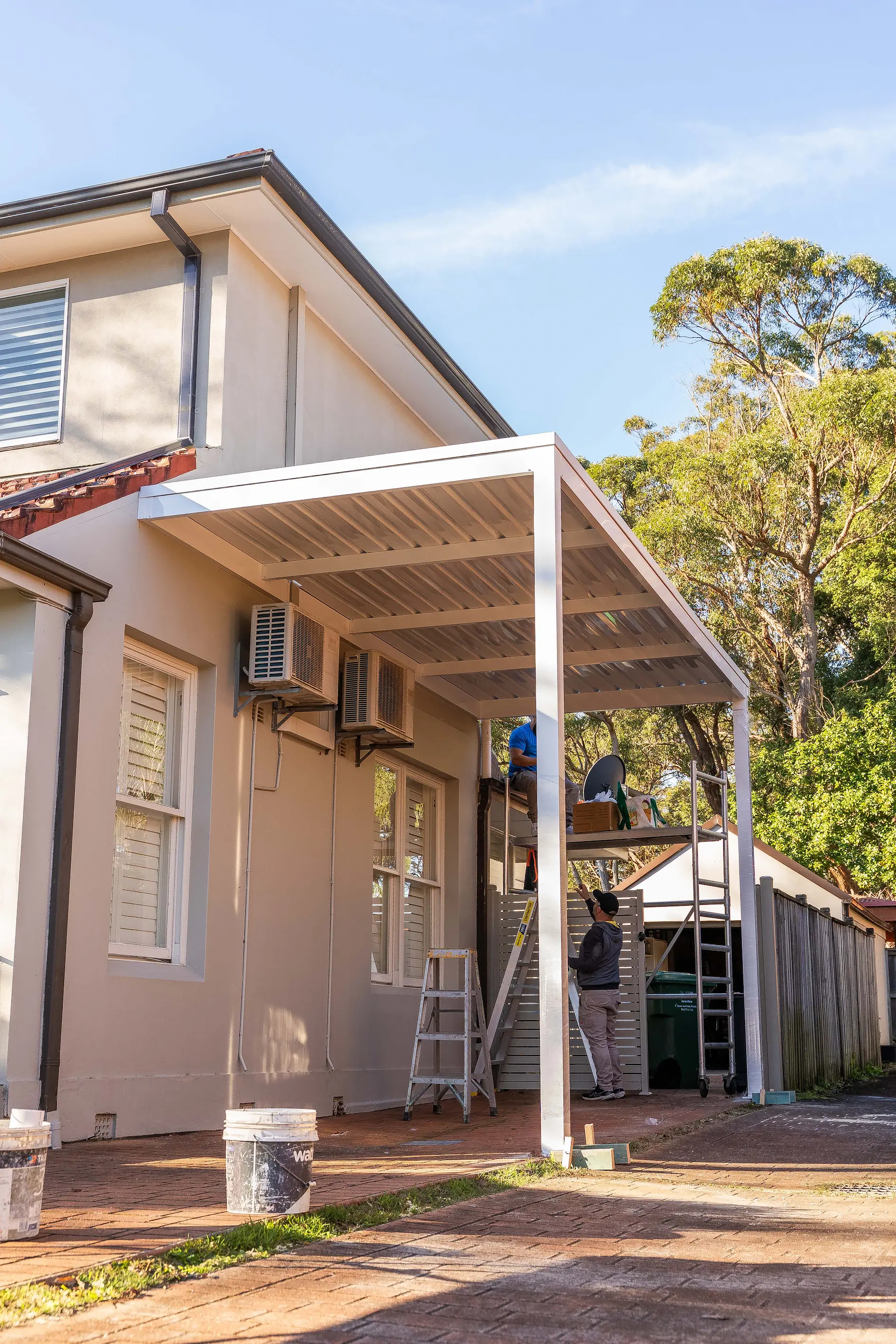 Wide view of a finished carport spanning the driveway beside a Sydney home