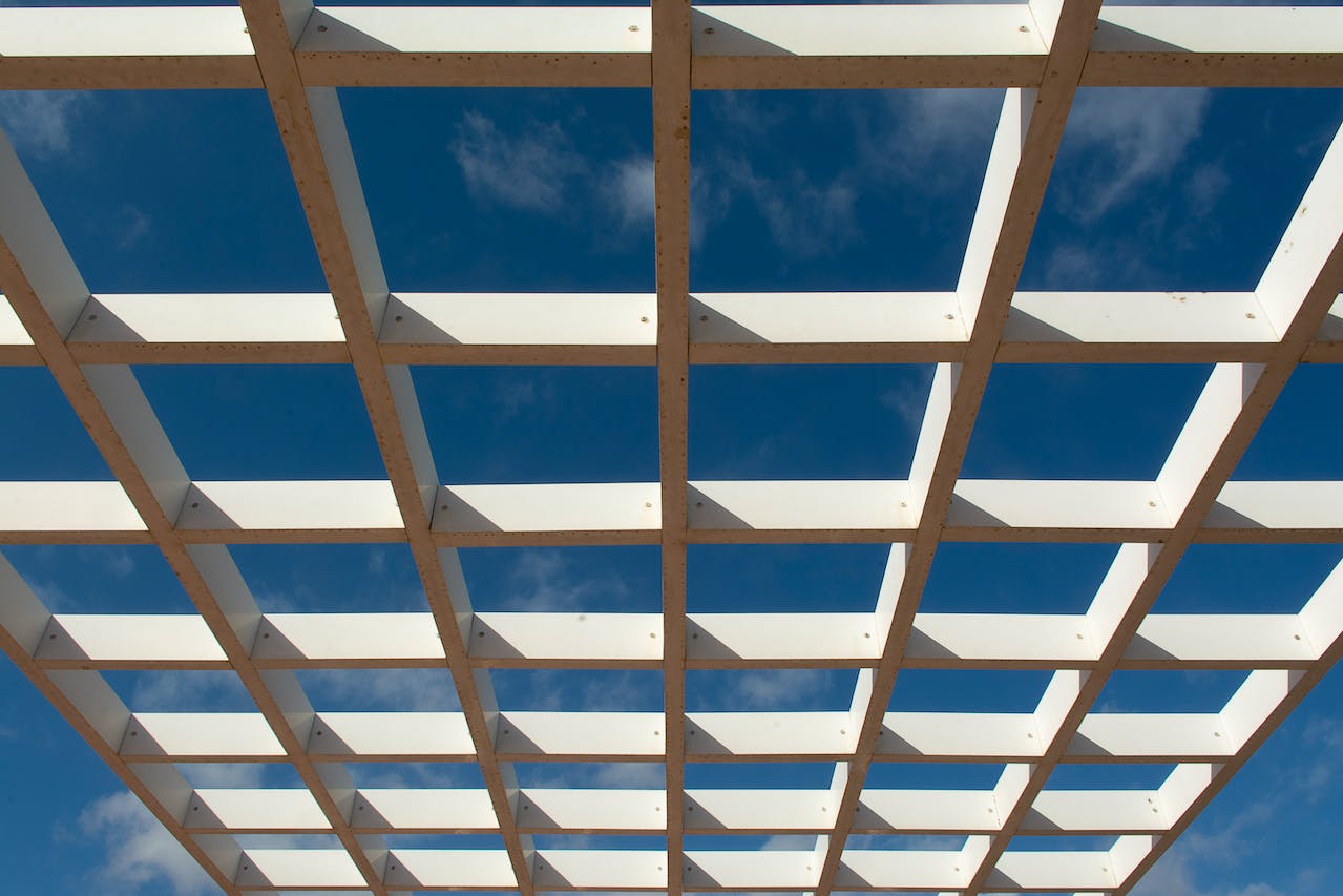 Custom pergola build with roof and outdoor seating area